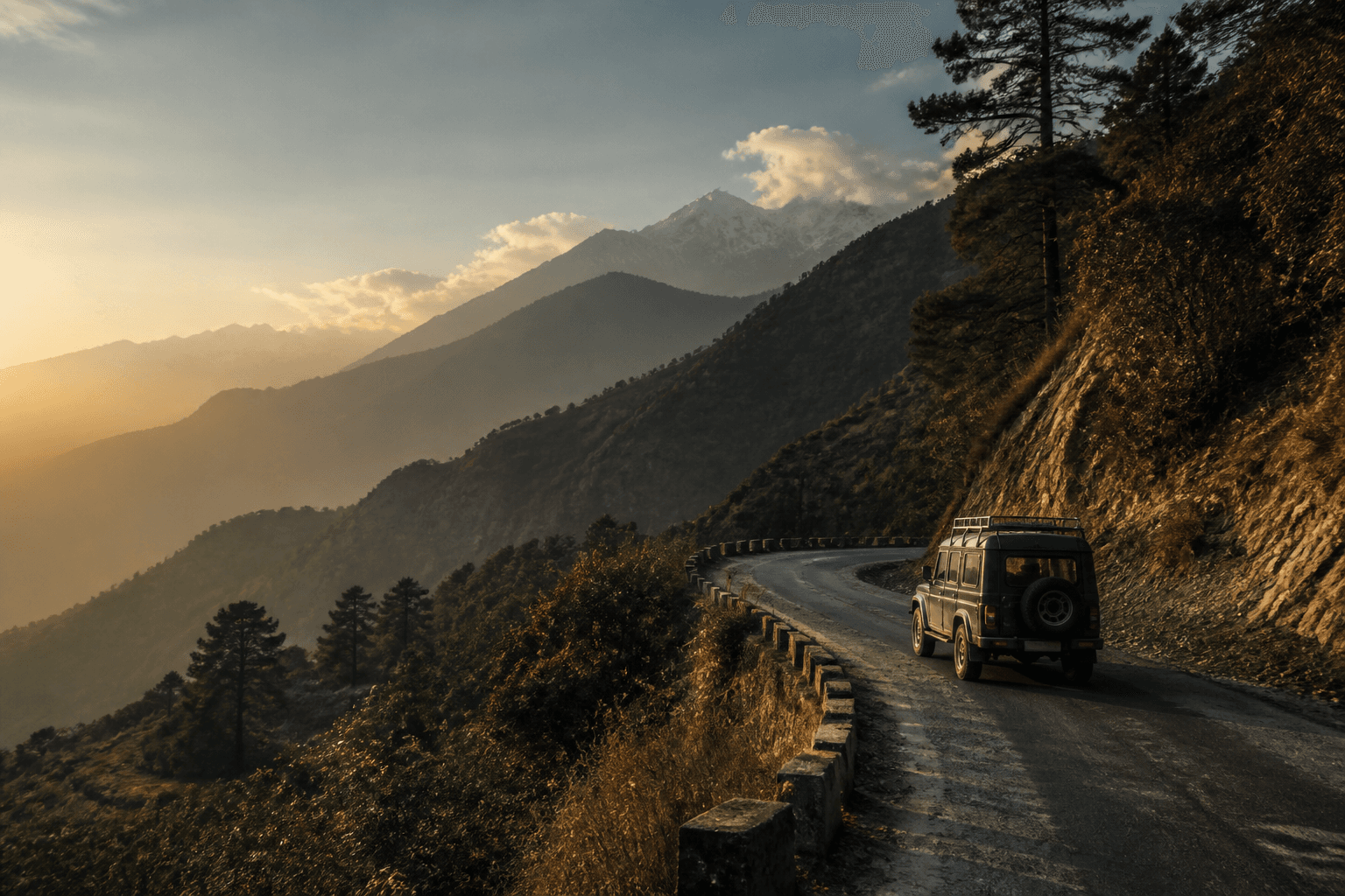 A jeep travelling along a Himalayan mountain road at sunrise